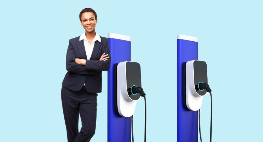 Photo of woman leaning against charging station