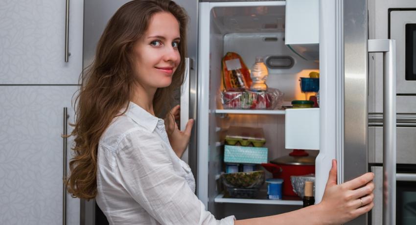 Woman opening fridge
