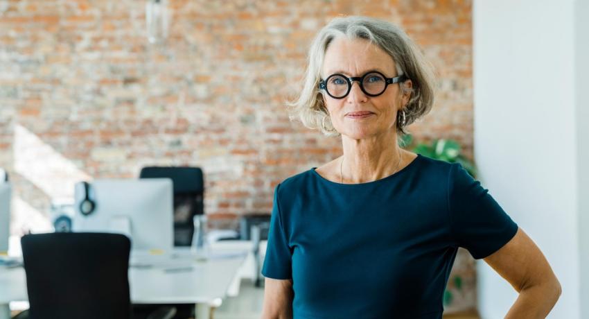 Woman smiling and standing in office