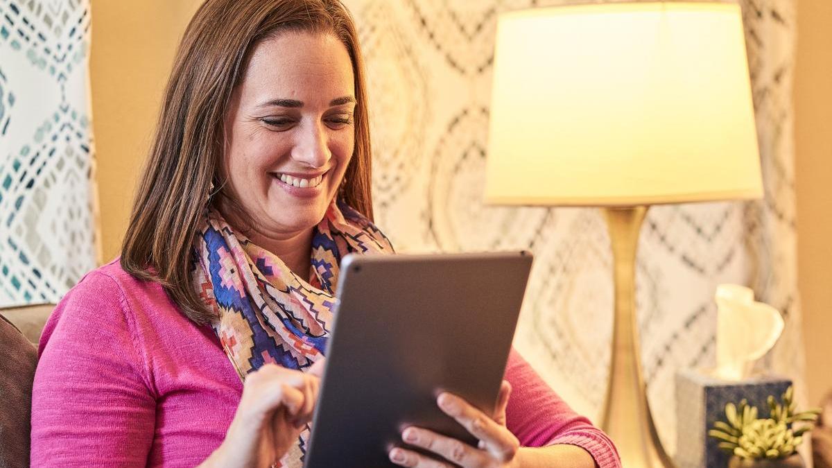 Woman Reading Articles on Tablet