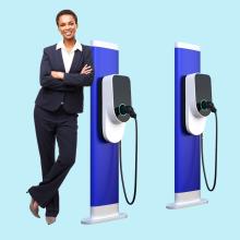 Photo of woman leaning against charging station