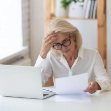 lady upset looking at bill on table