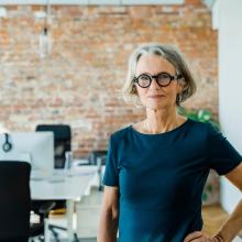 Woman smiling and standing in office