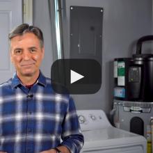 Man smiling, standing next to appliance